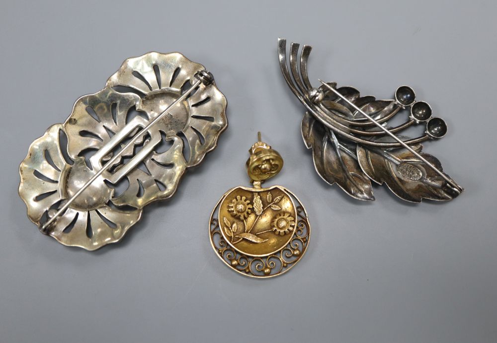 A single 14ct gold earring cast with flowers, a silver and marcasite openwork brooch and a Danish silver (925) leaf brooch